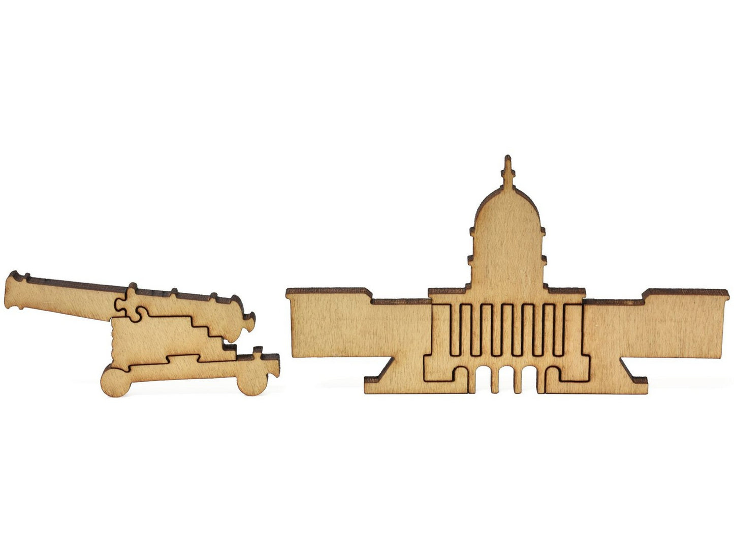 A closeup of pieces that shows the state capitol and a cannon.