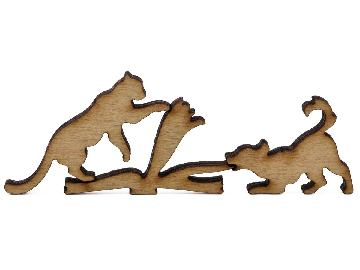 A closeup of pieces shaped like a cat and dog pulling on the pages of a book.