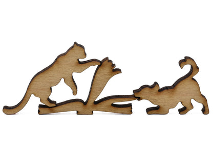 A closeup of pieces shaped like a cat and dog pulling on the pages of a book.