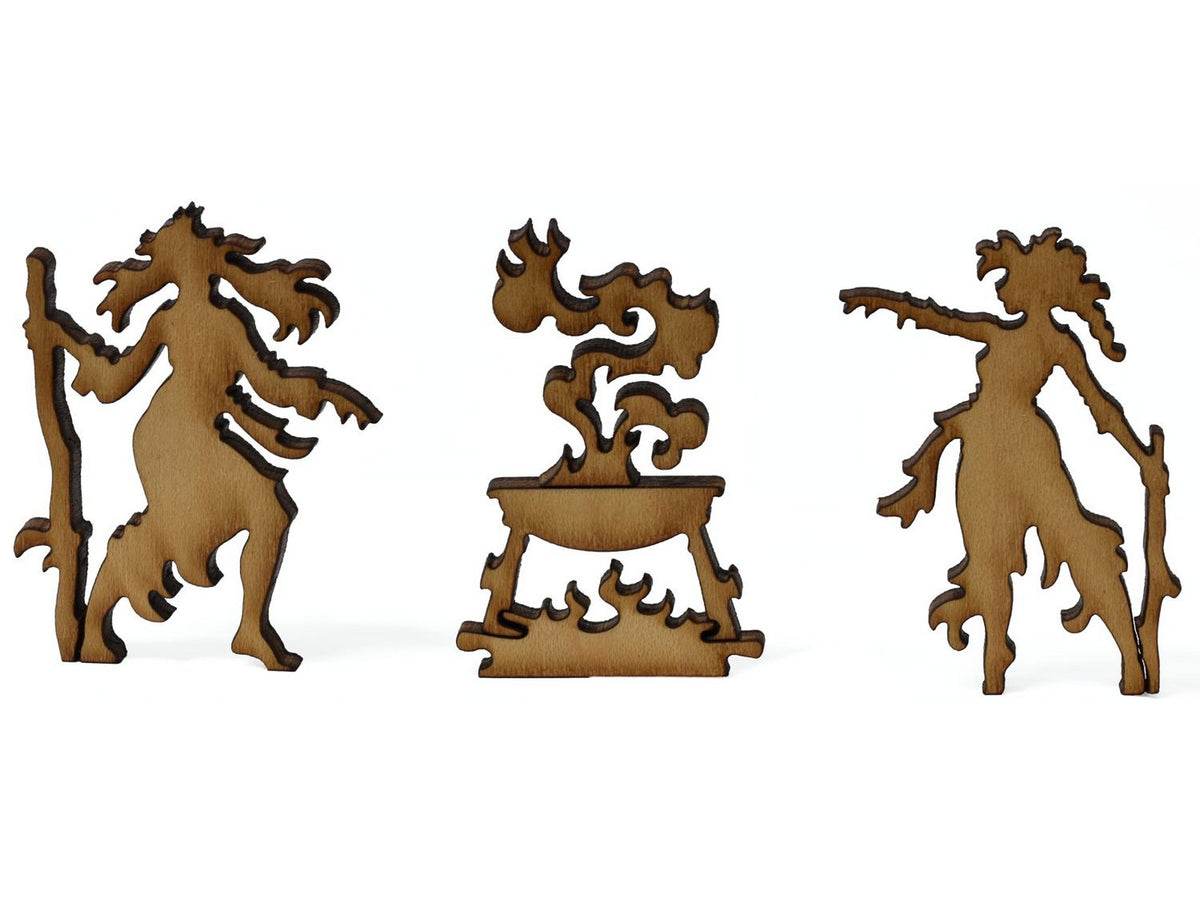 A closeup of pieces shaped like witches around a cauldron.