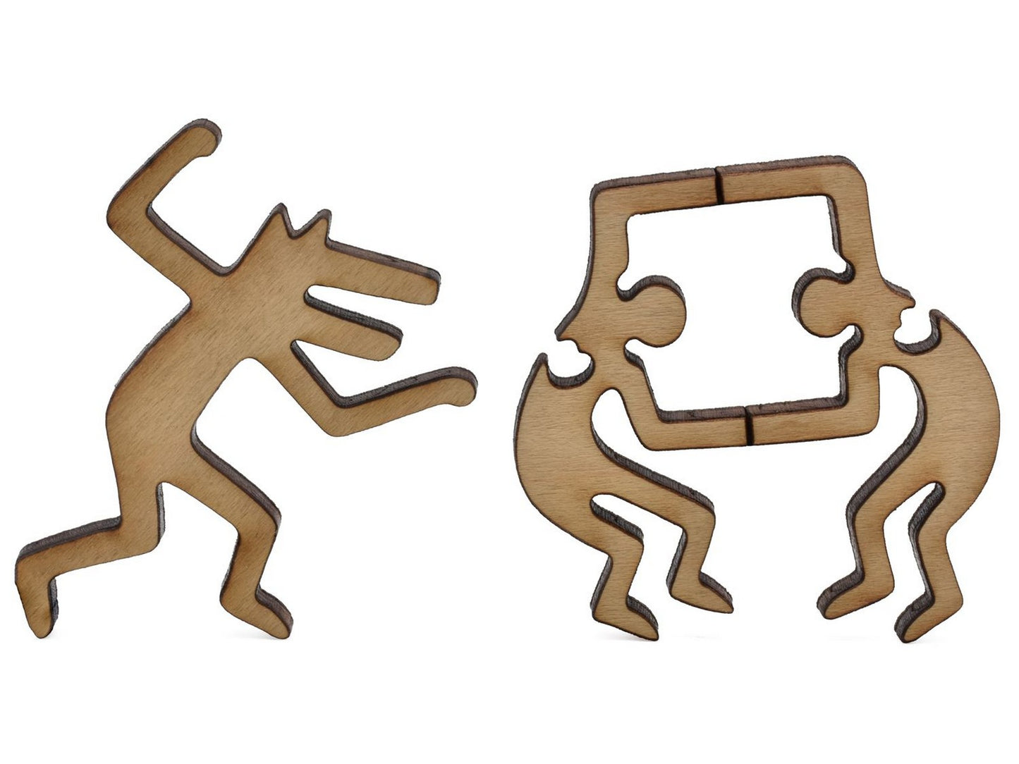 A closeup of pieces in the shape of two Keith Haring figures.