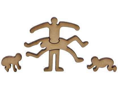 A closeup of pieces in the shape of three Keith Haring figures.