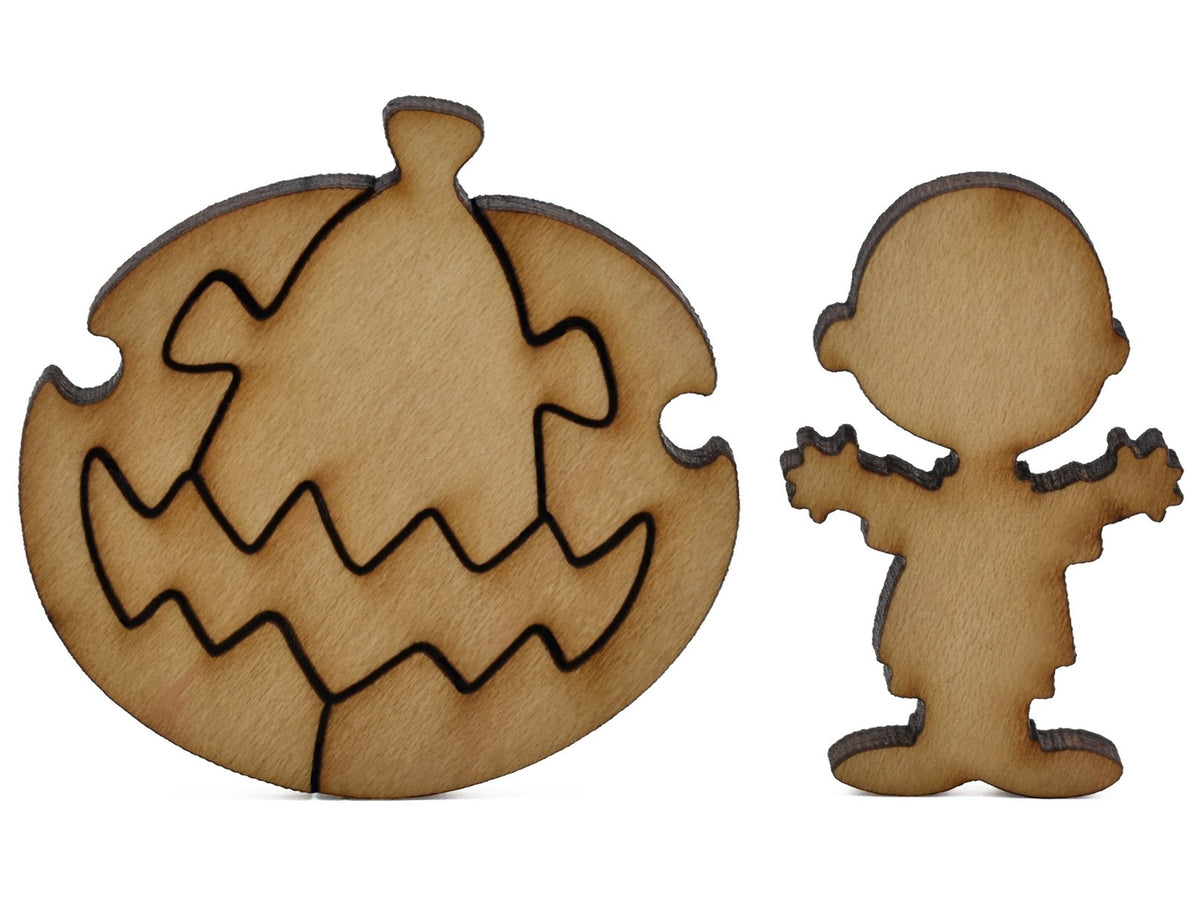 A closeup of pieces shaped like Charlie Brown and the Great Pumpkin.
