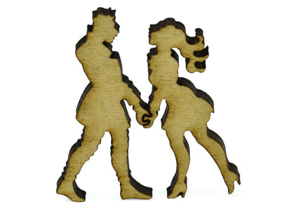A closeup of pieces in the shape of a couple holding hands.