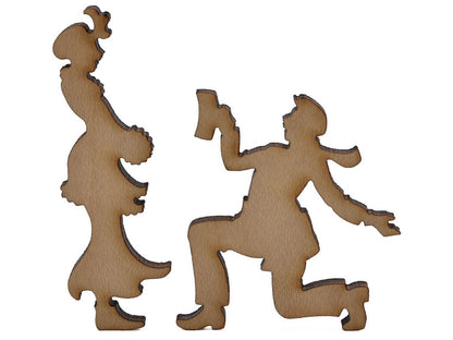 A closeup of pieces shaped like a couple with a kneeling figure.