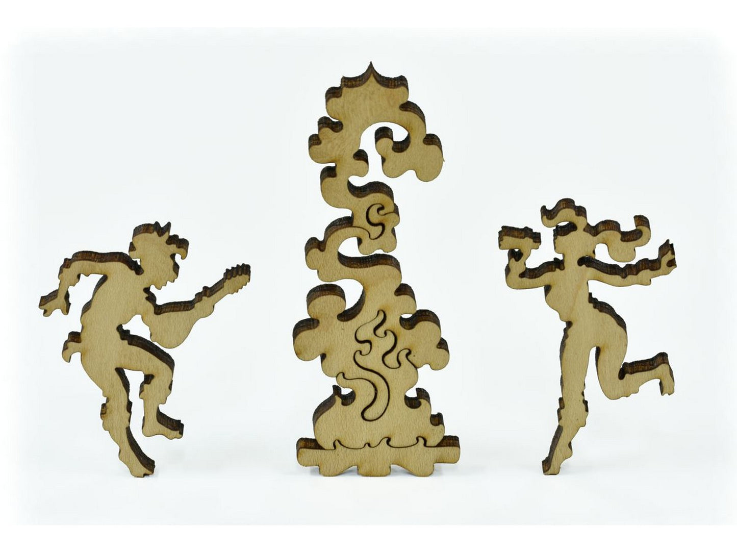 A closeup of pieces in the shape of people dancing around a campfire.