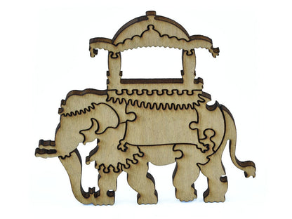 A closeup of pieces in the shape of an elephant with a saddle.