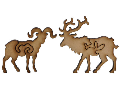 A closeup of pieces shaped like a big horn sheep and an elk.
