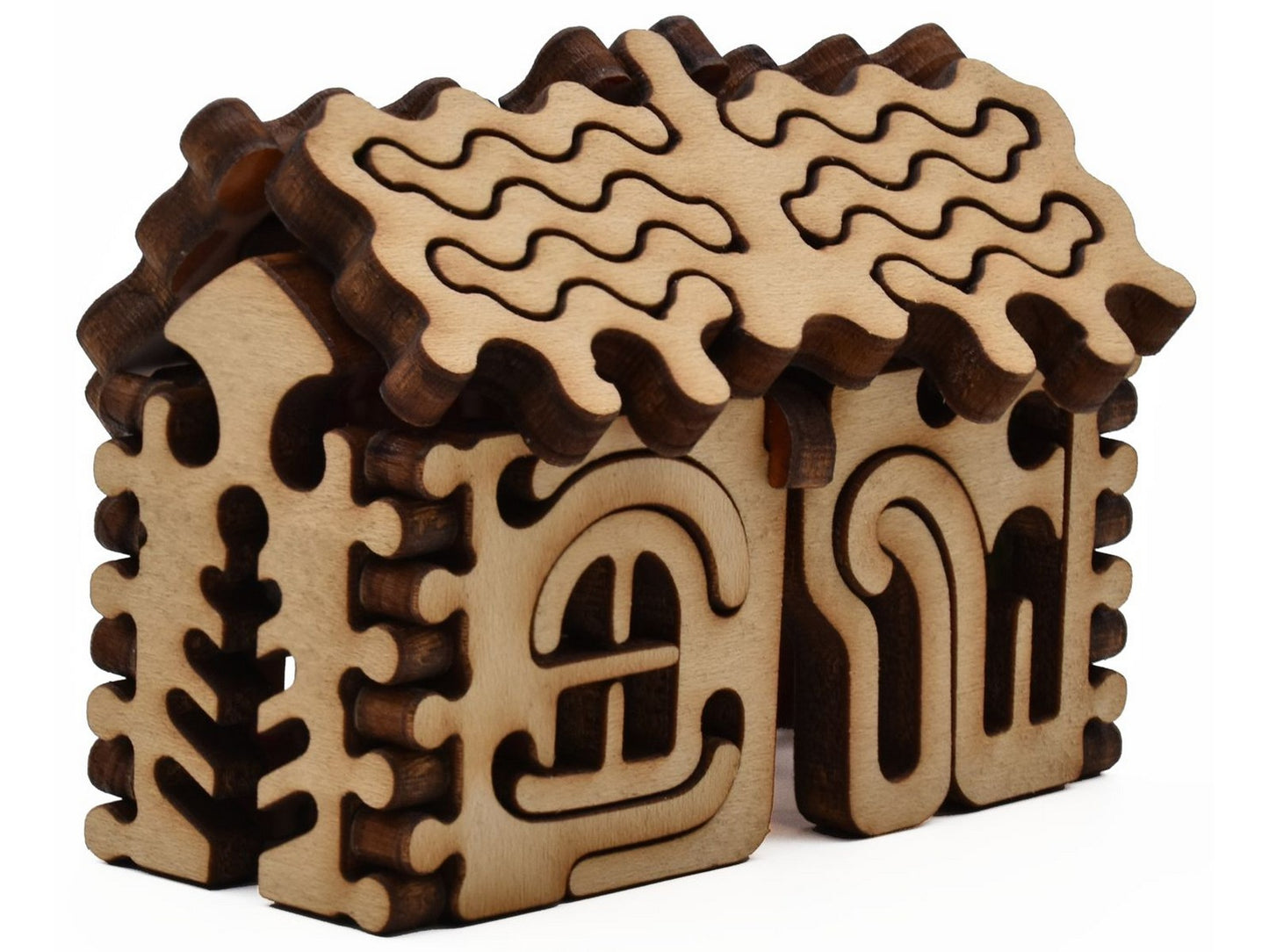 A closeup of pieces shaped like a three dimensional gingerbread house.