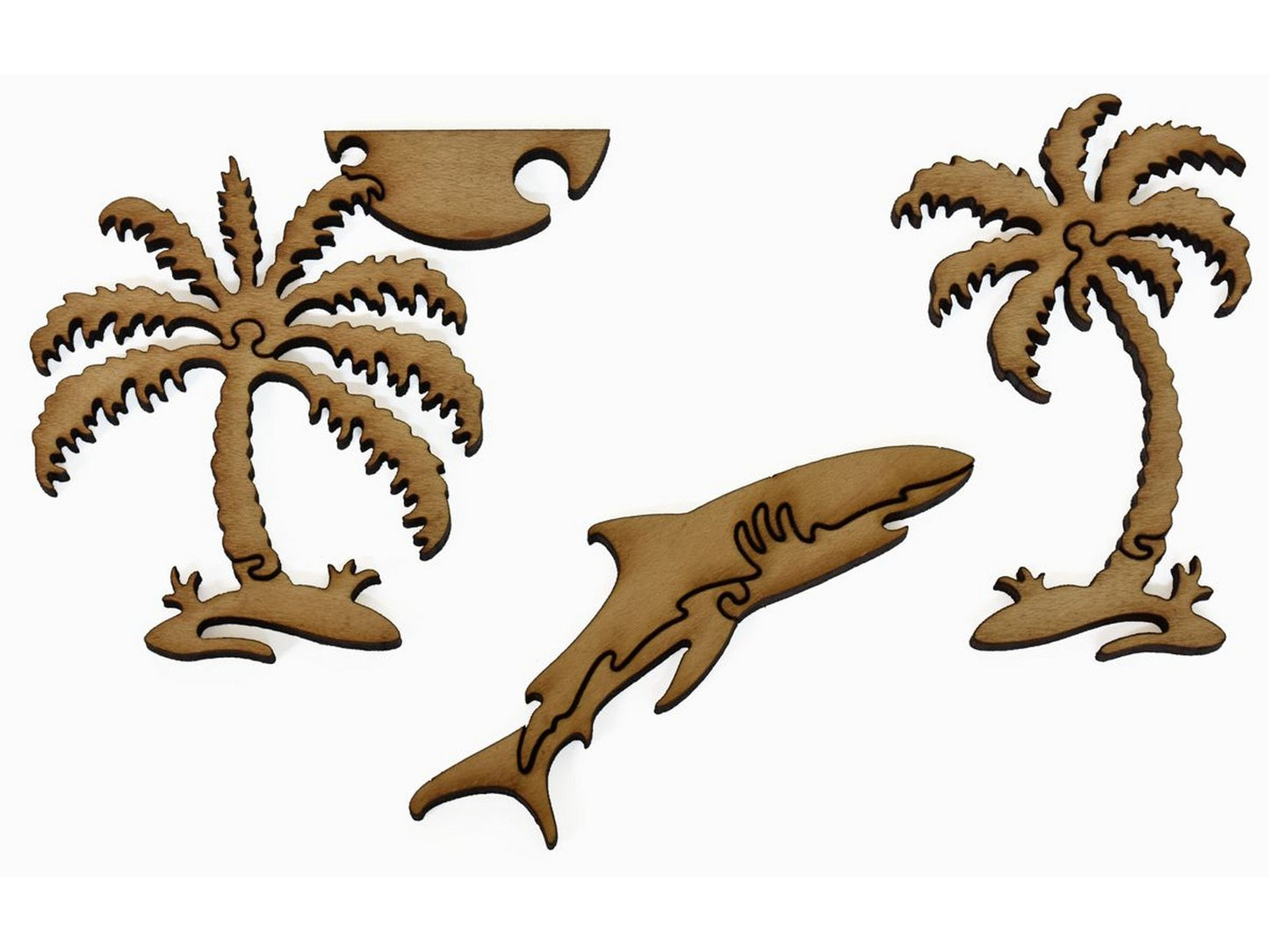 A closeup of pieces showing a shark and two palm trees with the sun.