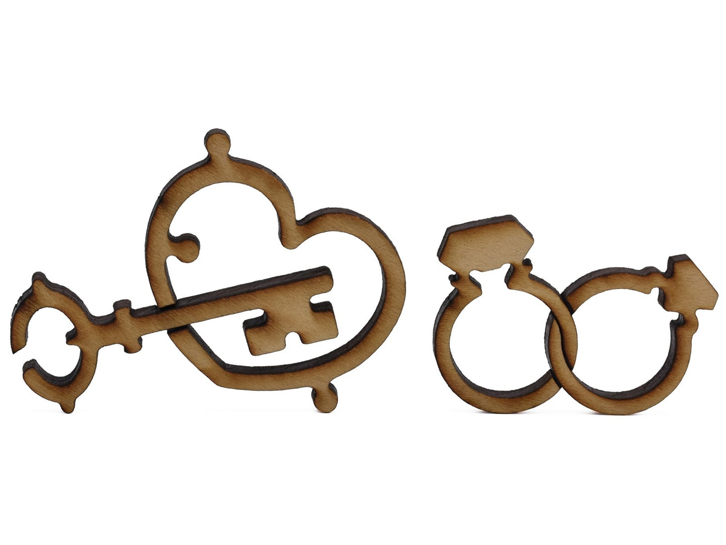 A closeup of pieces shaped like a key, heart, and two intertwined rings.