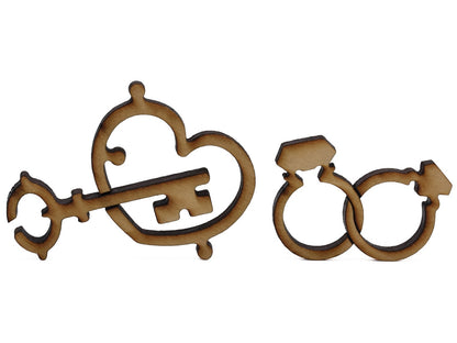 A closeup of pieces shaped like a key, heart, and two intertwined rings.
