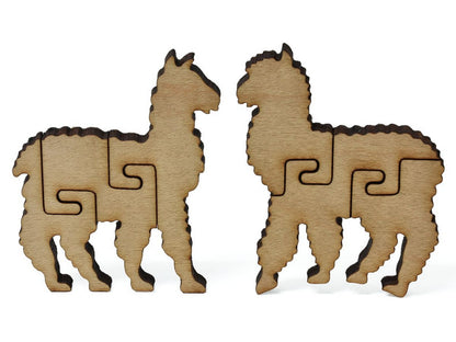 A closeup of pieces showing two stylized Incan llamas.