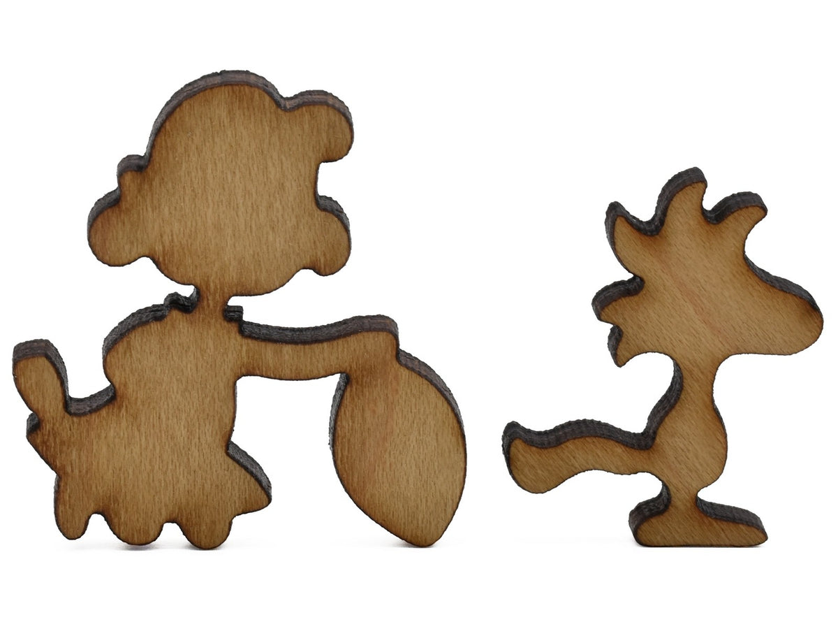 A closeup of pieces shaped like Lucy and Woodstock.