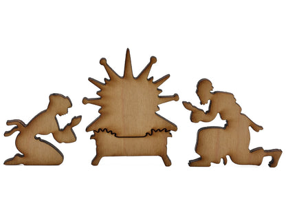 A closeup of pieces shaped like Mary, Joseph, and the manger.