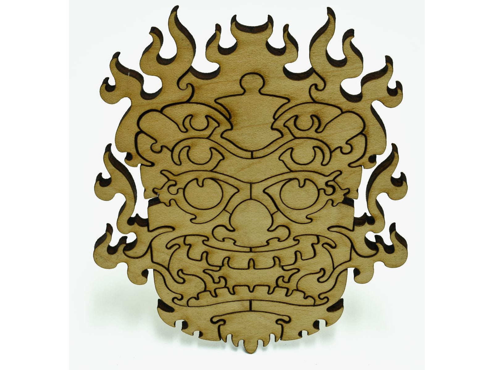 A closeup of pieces shaped like a tribal mask.