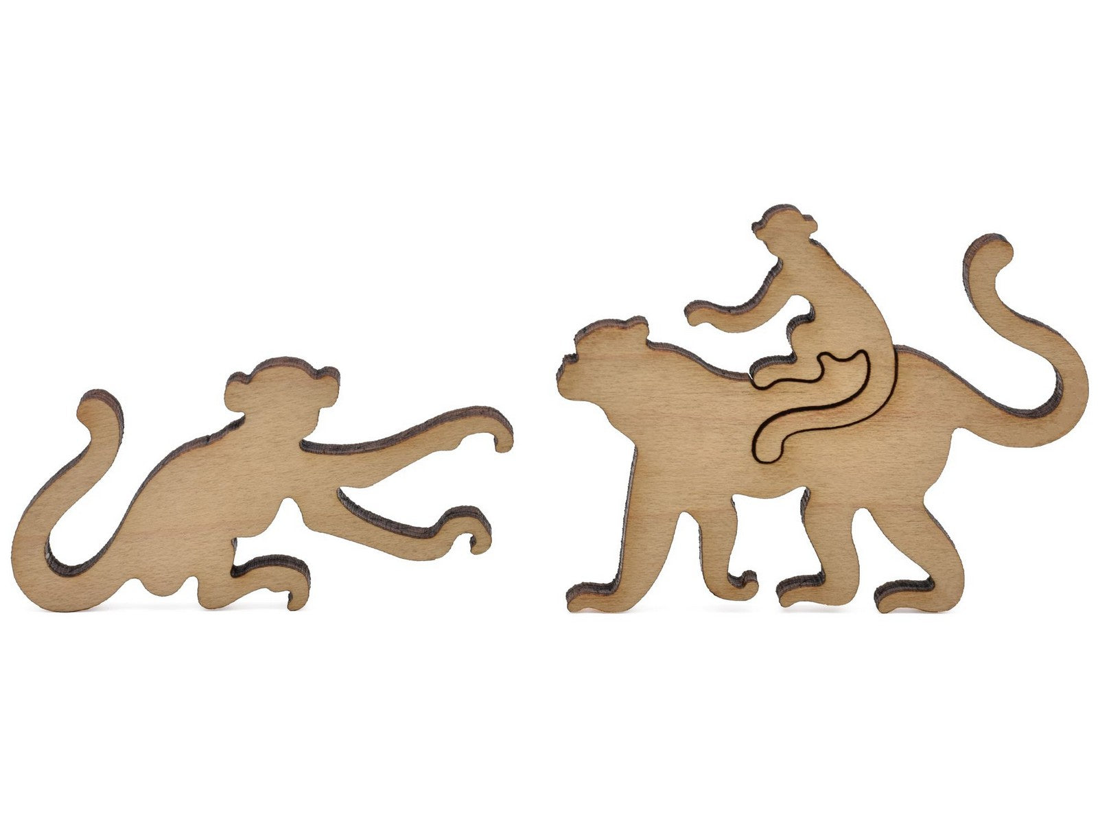 A closeup of pieces shaped like two monkeys, one with a baby on its back.