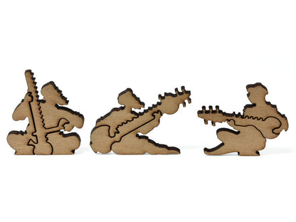 A closeup of pieces shaped like three people playing instruments.