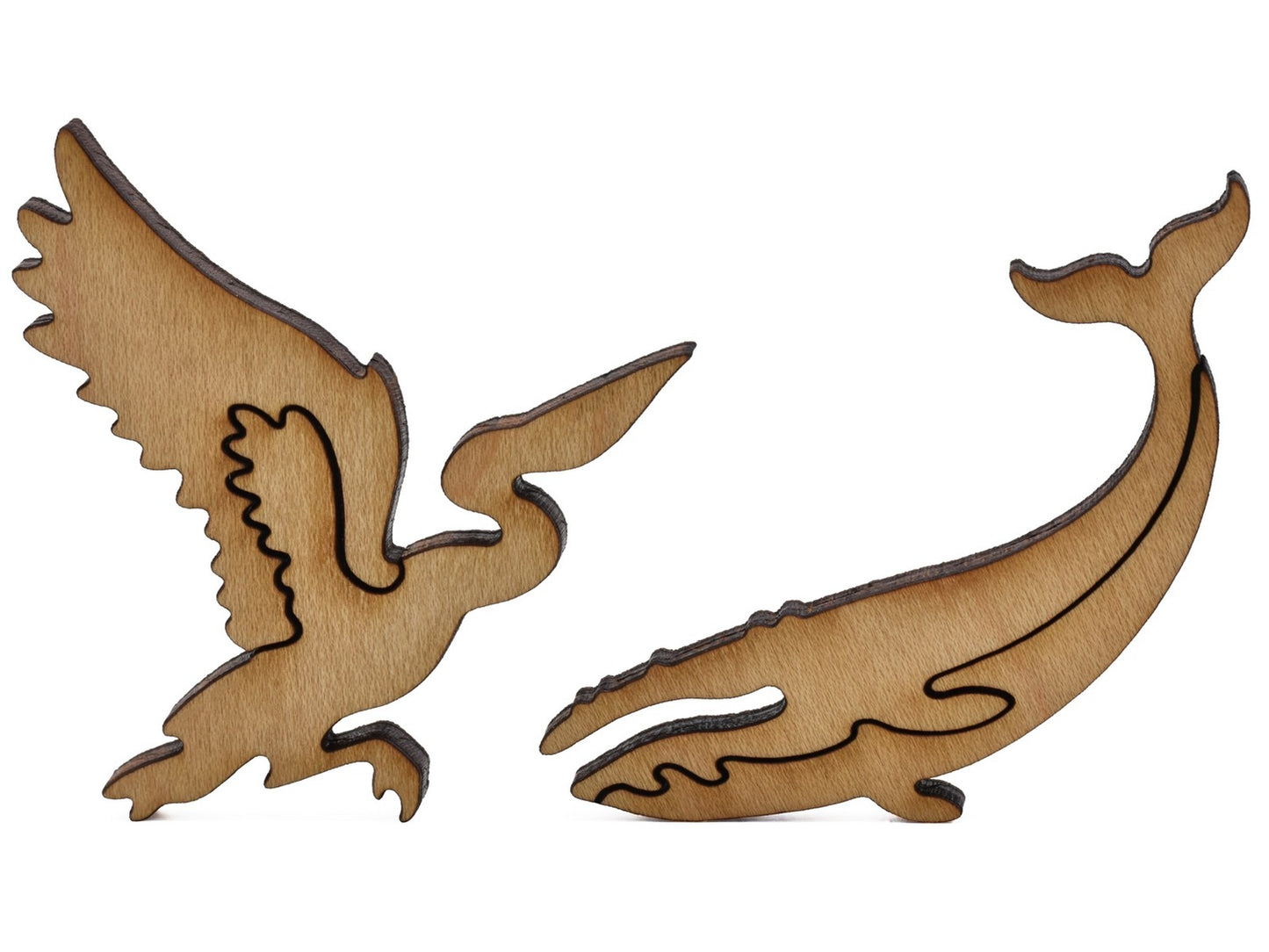 A closeup of pieces shaped like a pelican and a whale.