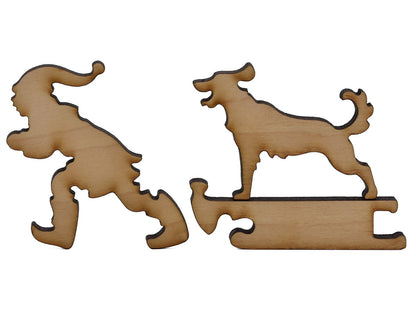 A closeup of pieces shaped like a person pulling a dog on a sled.