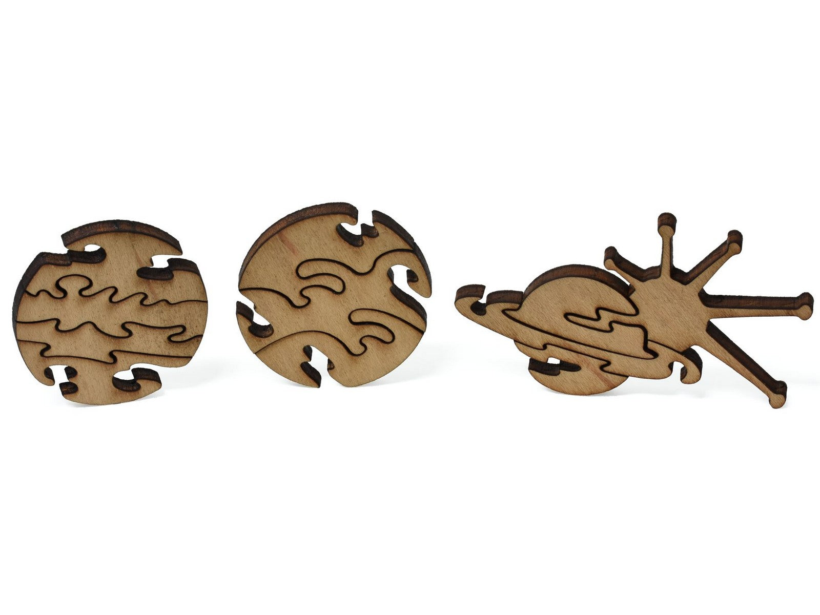 A closeup of pieces shaped like three planets.