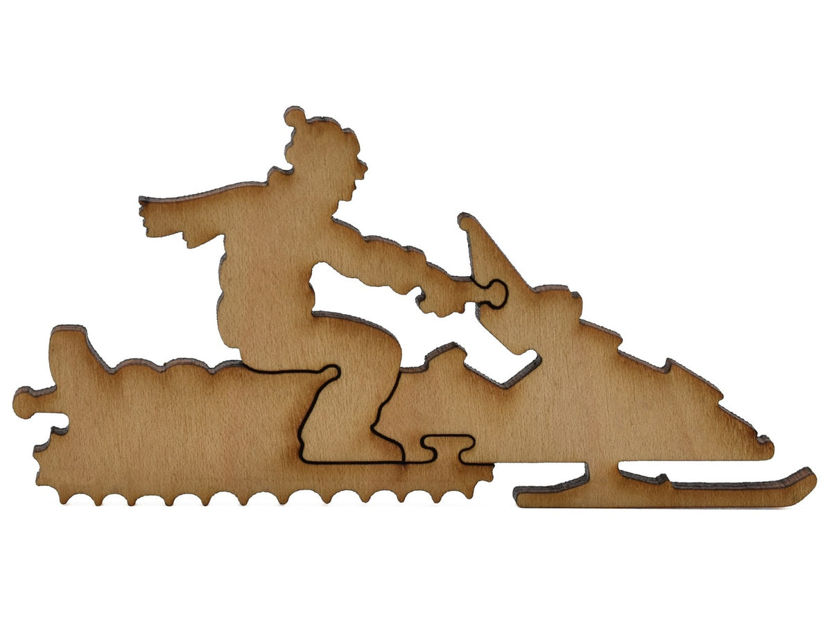 A closeup of pieces shaped like a person riding a snowmobile.