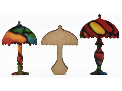 A closeup of pieces shaped like three Tiffany lamps.