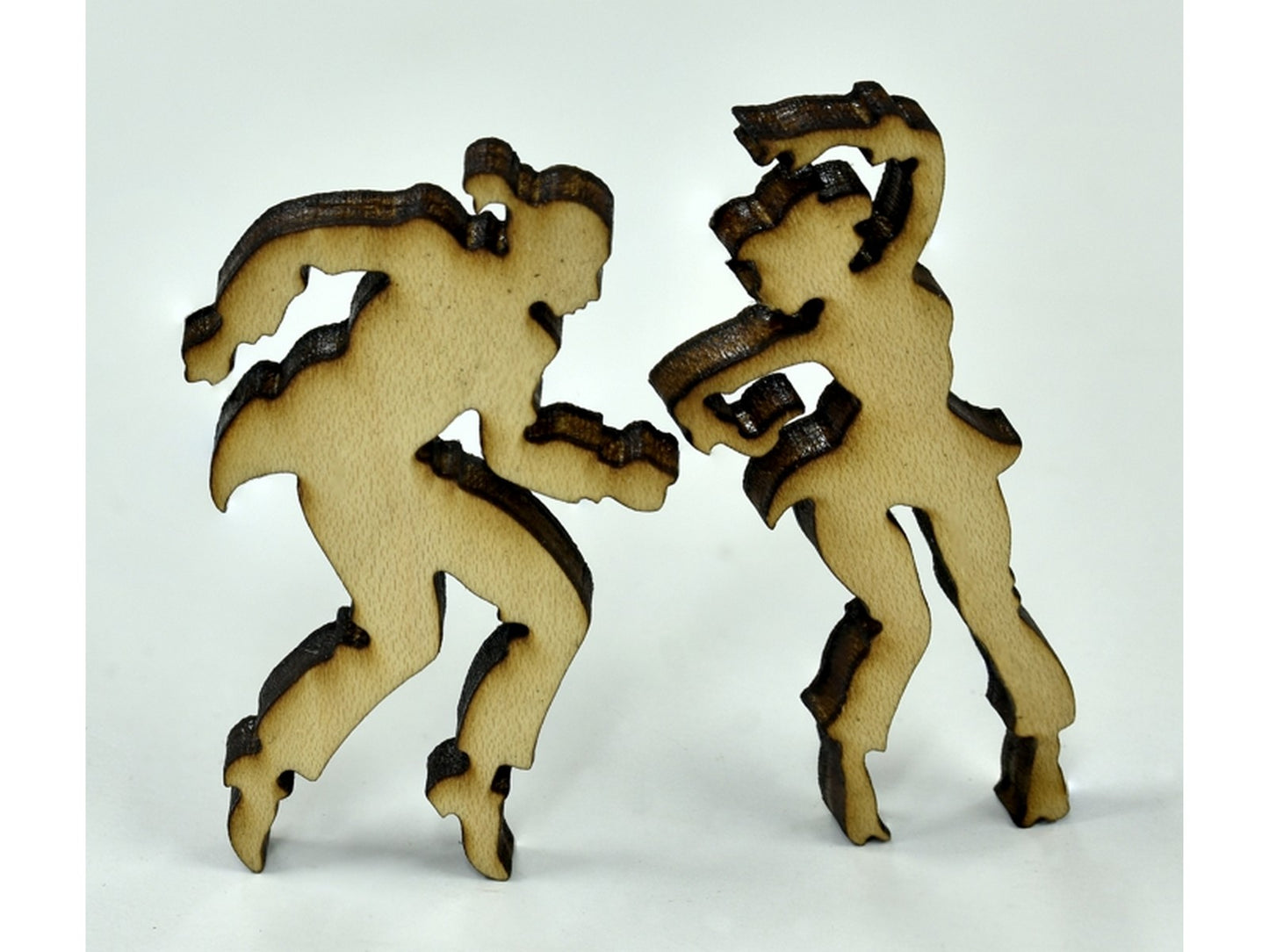 A closeup of pieces in the shape of two people dancing.