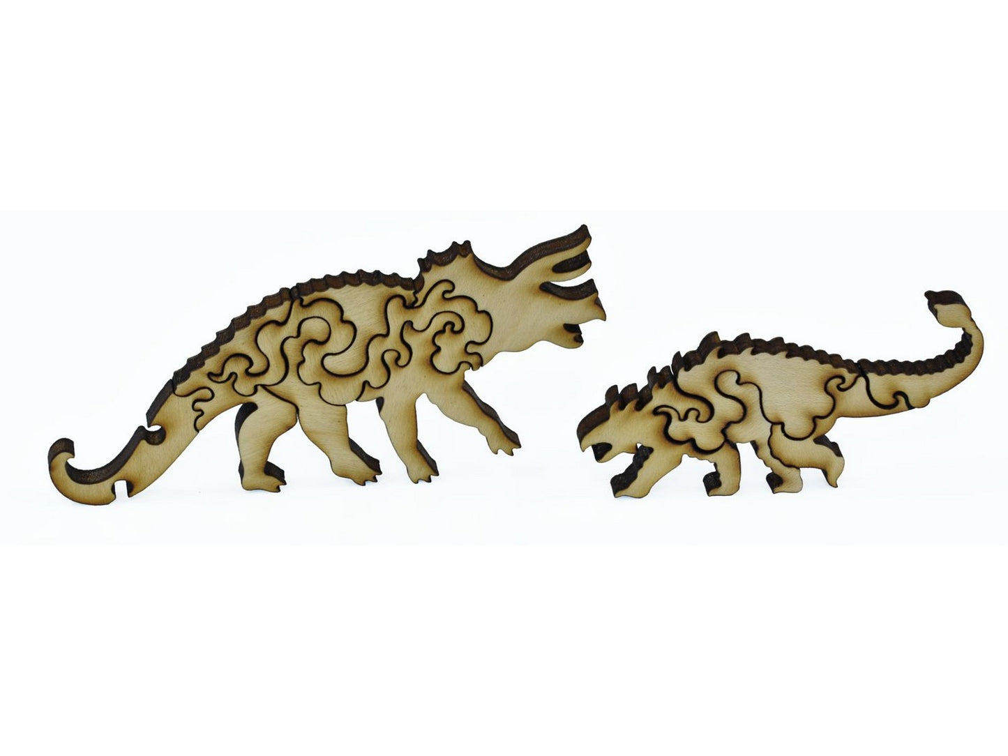 A closeup of pieces shaped like a Triceratops and an Ankylosaurus.