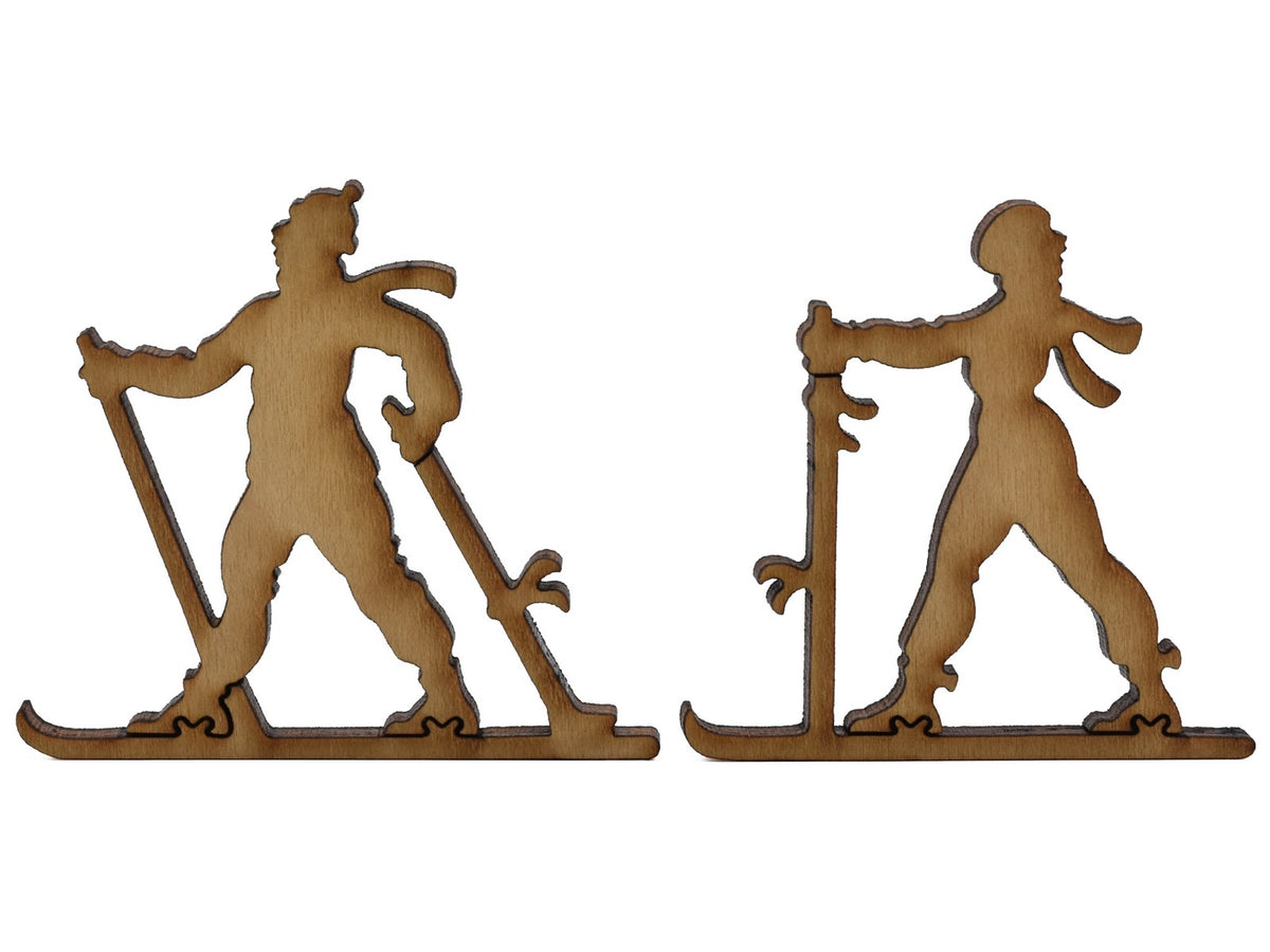 A closeup of pieces shaped like two people cross country skiing.