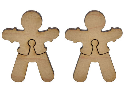 A closeup of pieces shaped like two gingerbread men.