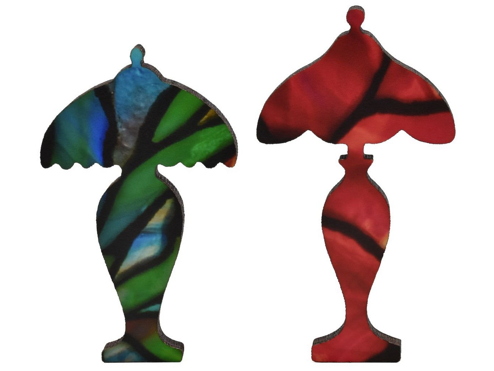 A closeup of pieces shaped like two Tiffany Lamps.