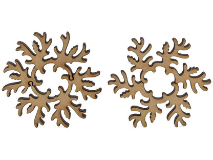 A closeup of pieces shaped like two large ornamental snowflakes.