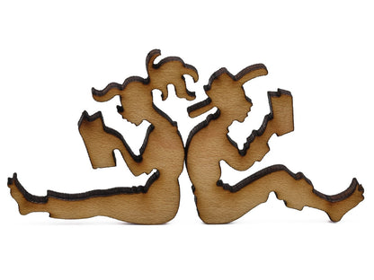 A closeup of pieces shaped like two people sitting back to back and reading.
