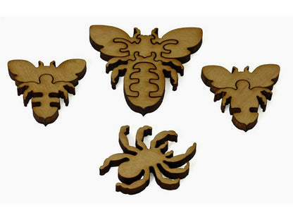 A closeup of pieces showing three bees and a spider.