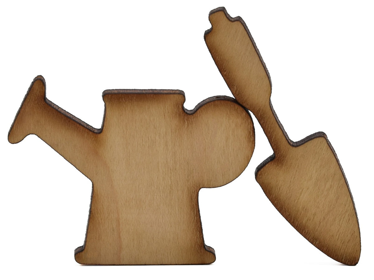 A closeup of pieces shaped like a watering can and a spade.