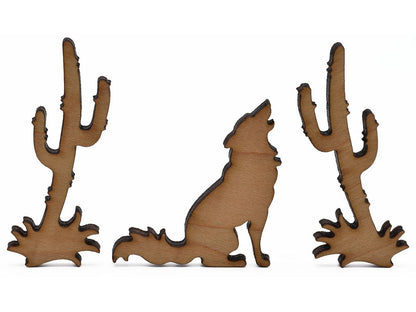 A closeup of pieces shaped like a coyote and two cacti.