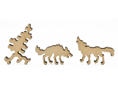 A closeup of pieces in the shape of two wolves and a tree.