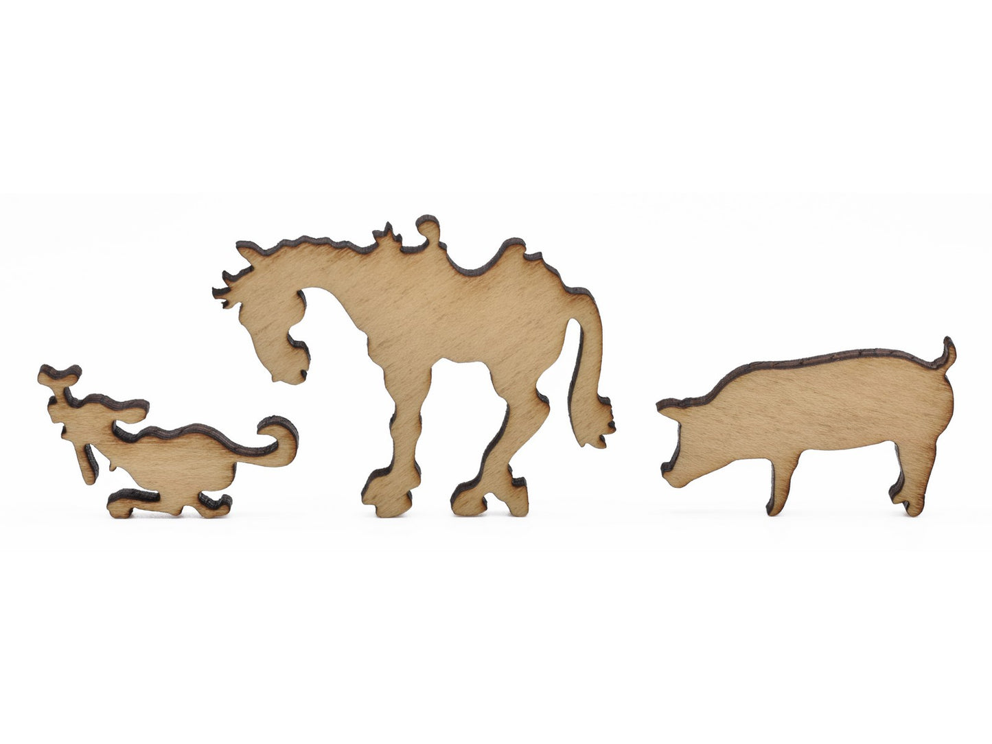 A closeup of pieces in the shape of a dog, a horse, and a pig.