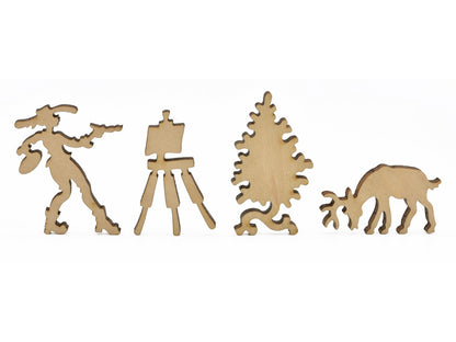 A closeup of pieces in the shape of an artist, a tree, and a deer.