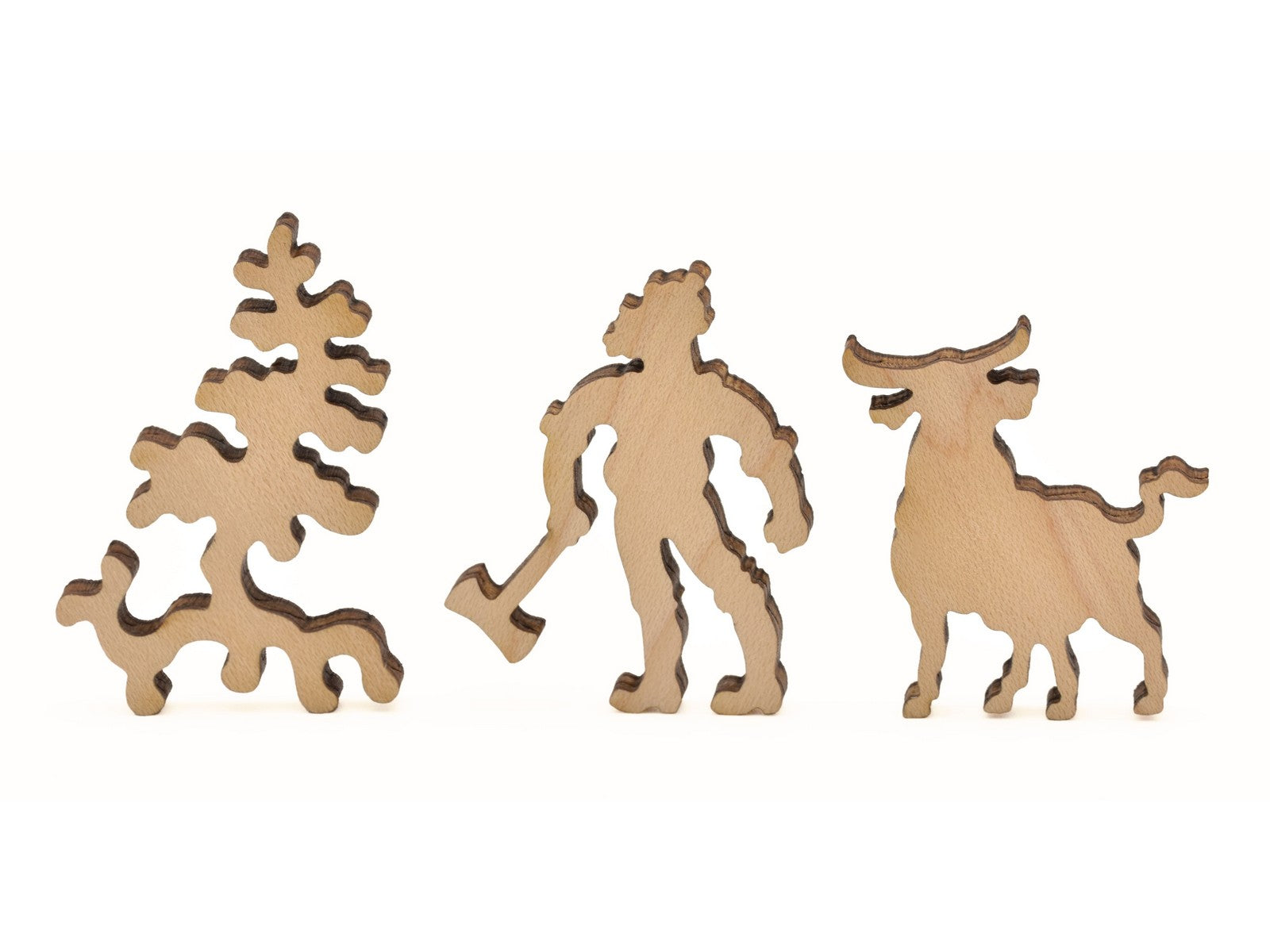 A closeup of pieces in the shape of a tree, a lumberjack, and a bull.