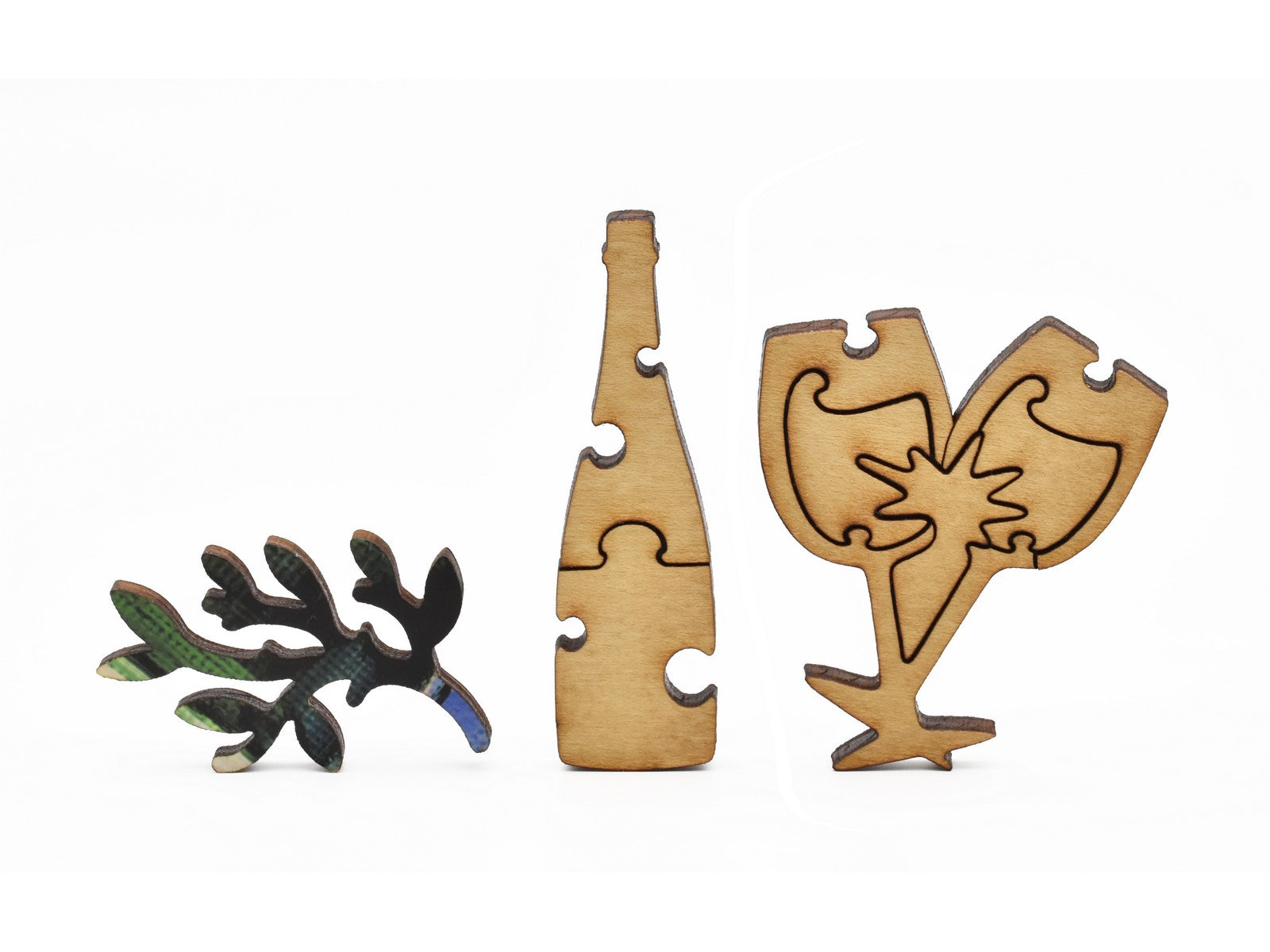 A closeup of pieces in the shape of champagne, glasses, and a branch.