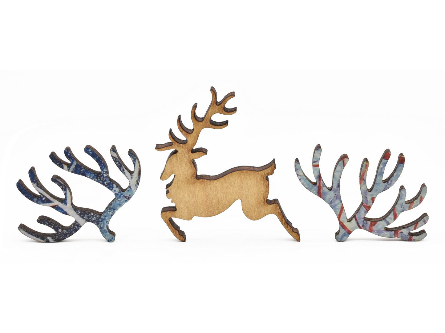 A closeup of pieces in the shape of a deer and branches.