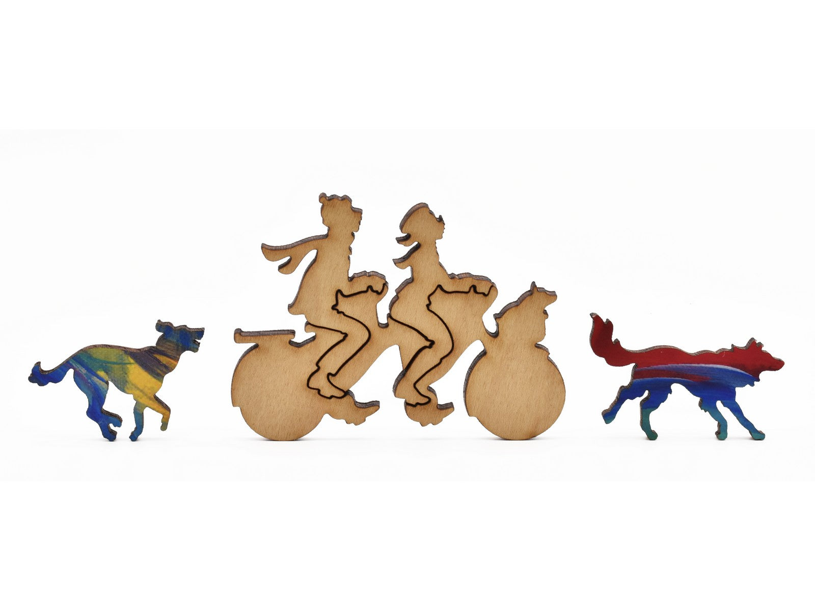 A closeup of pieces in the shape of people riding a tandem bike and two dogs.