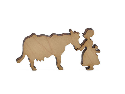 A closeup of pieces in the shape of a girl and a cow.