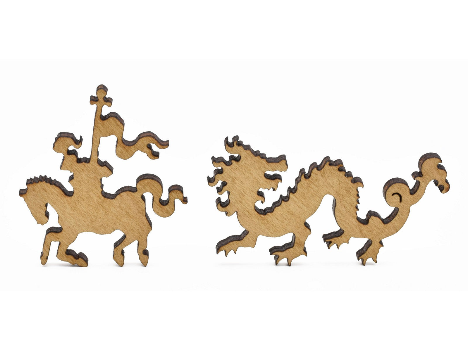 A closeup of pieces in the shape of a dragon and a knight.