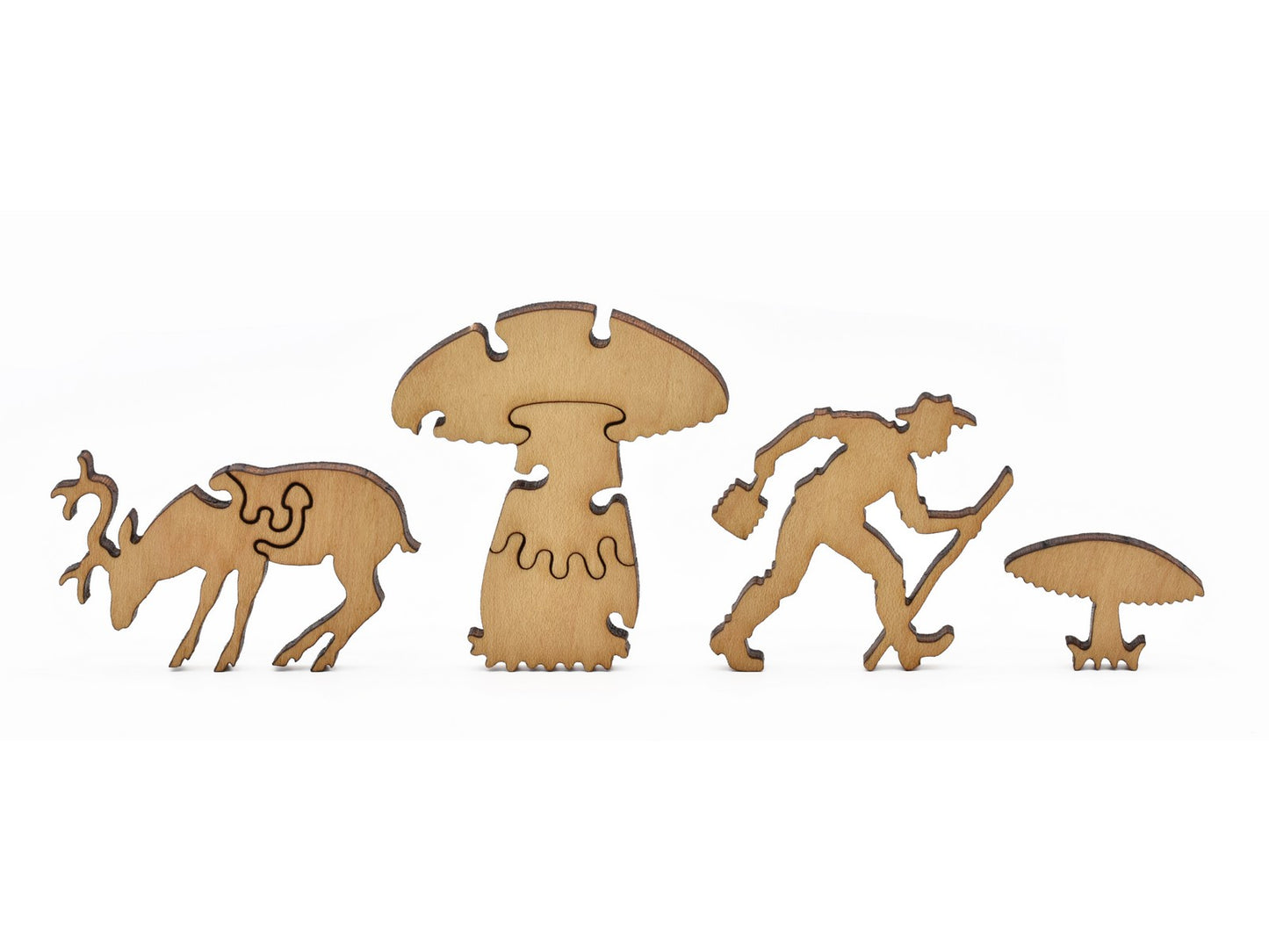 A closeup of pieces in the shape of a deer, a hiker, and mushrooms.