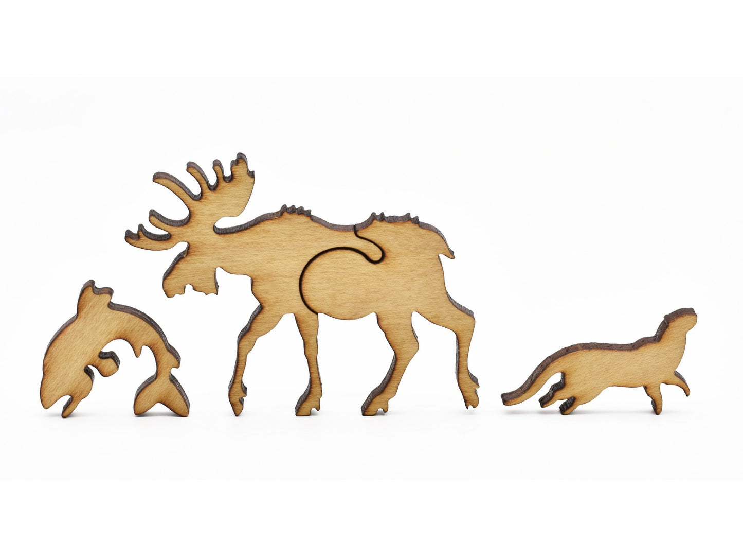 A closeup of pieces showing a moose, fish, and an otter.