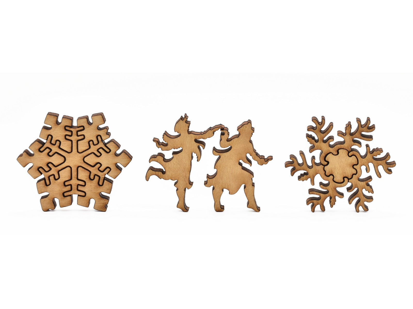 A closeup of pieces in the shape of snowflakes and people dancing.