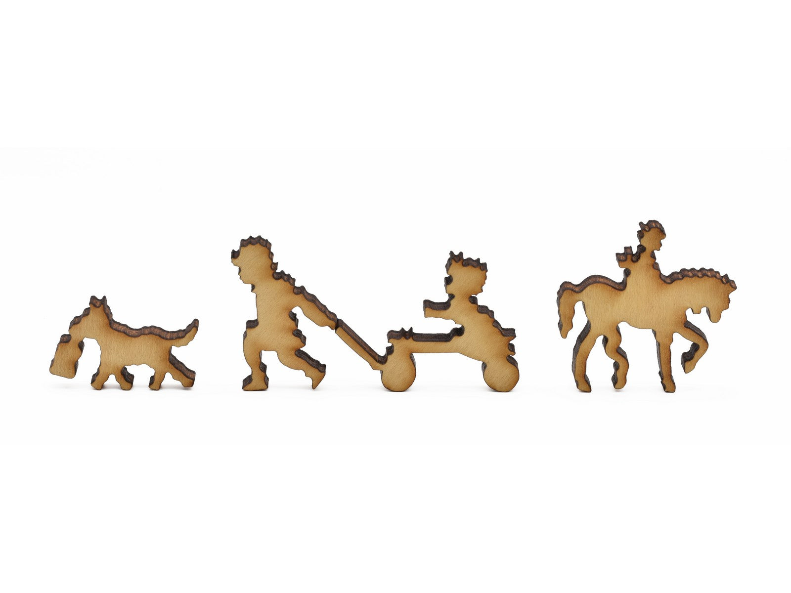 A closeup of pieces in the shape of children playing and a dog.